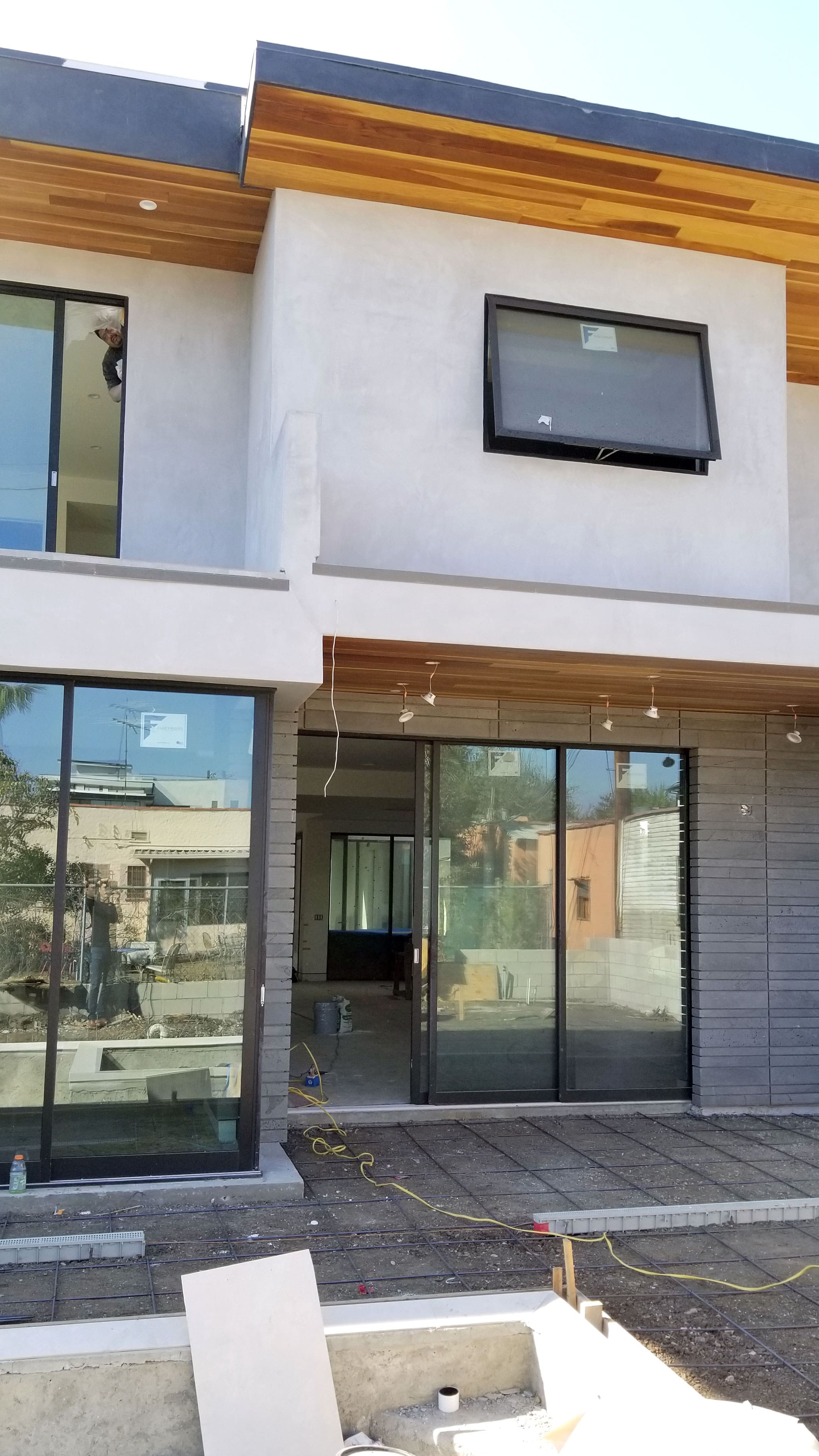 Norstone Platinum Planc Large Format Tile used on the exterior of a modern home around large sliding glass doors in Hollywood, CA